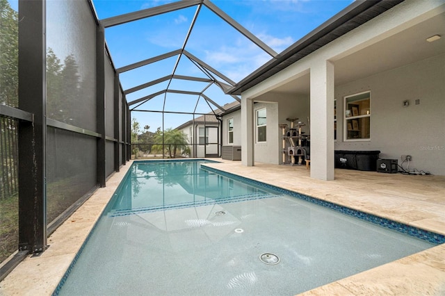 view of swimming pool with a lanai and a patio