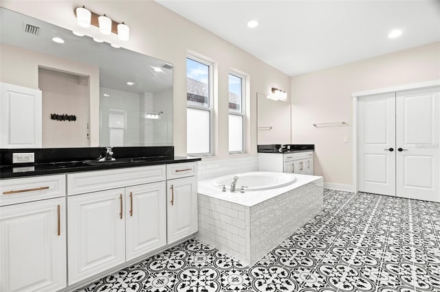 bathroom featuring vanity, separate shower and tub, and tile patterned flooring