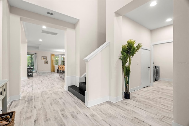 hall featuring light hardwood / wood-style floors and independent washer and dryer