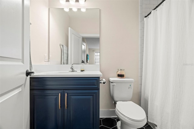 bathroom featuring toilet, vanity, a shower with curtain, and tile patterned flooring