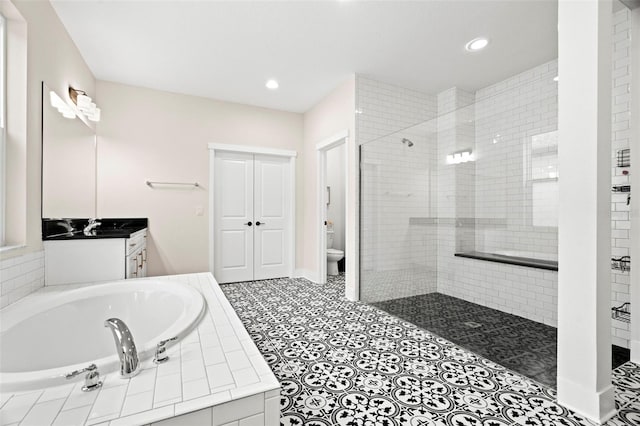 1012 Fernleaf Run, Bradenton, FL 34212 - bathroom with a stall shower, a garden tub, toilet, vanity, and recessed lighting
