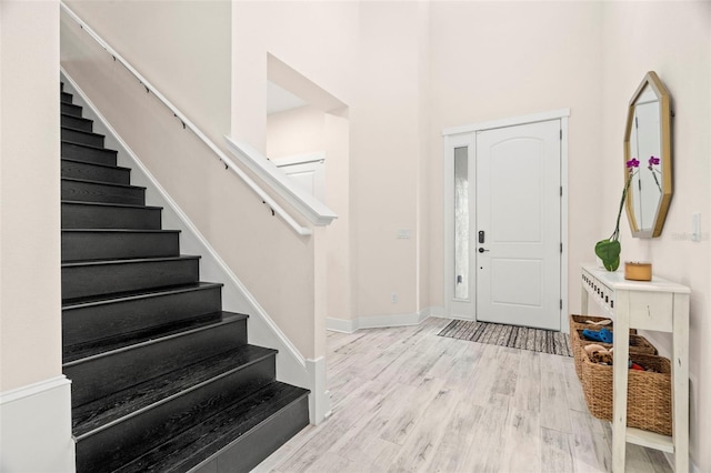 1012 Fernleaf Run, Bradenton, FL 34212 - foyer with stairway, wood finished floors, baseboards, and a towering ceiling