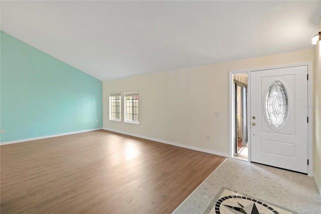 entryway featuring lofted ceiling and light wood-type flooring