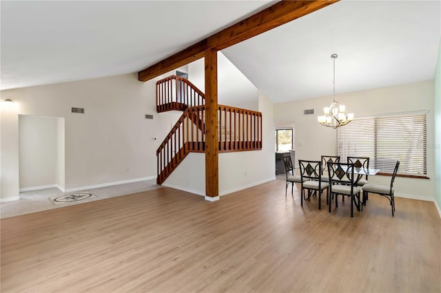 dining area featuring beamed ceiling, high vaulted ceiling, a chandelier, and light hardwood / wood-style floors