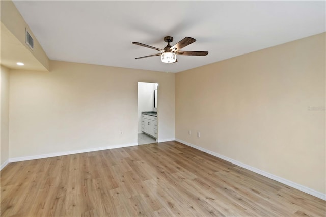 empty room featuring ceiling fan and light hardwood / wood-style floors