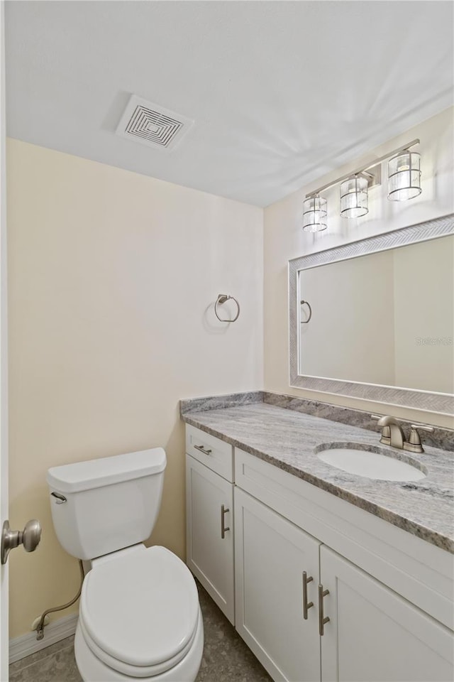 bathroom featuring vanity and toilet