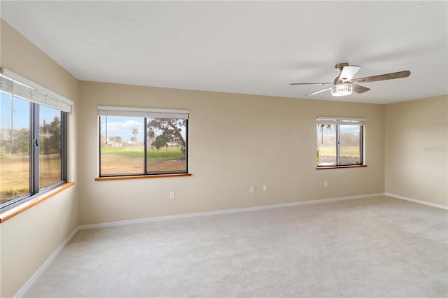 spare room with light carpet and ceiling fan