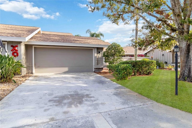 ranch-style house with a garage and a front lawn