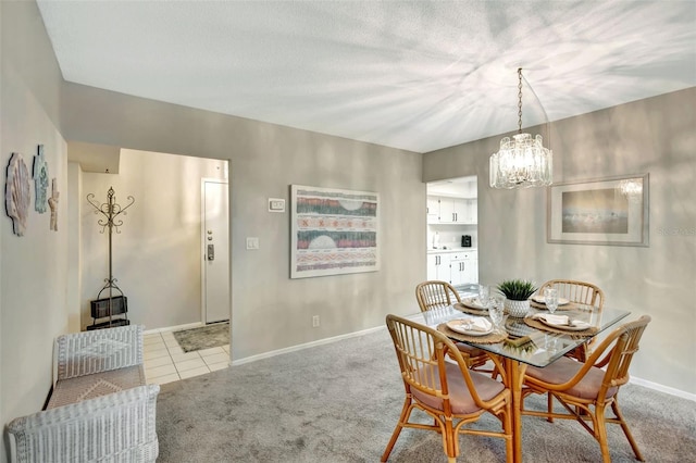 dining room featuring light colored carpet and a notable chandelier