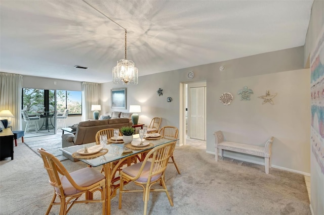 carpeted dining area with a notable chandelier