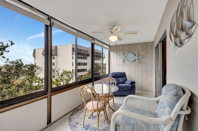 sunroom / solarium featuring ceiling fan