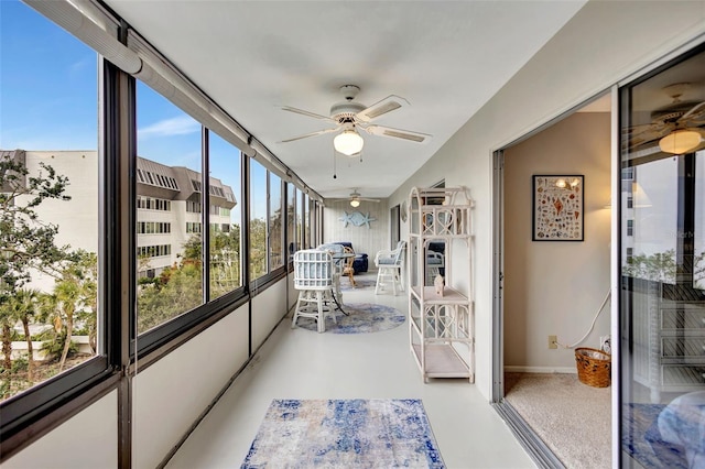 sunroom / solarium featuring plenty of natural light and ceiling fan