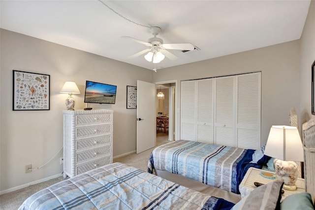 carpeted bedroom with a closet and ceiling fan