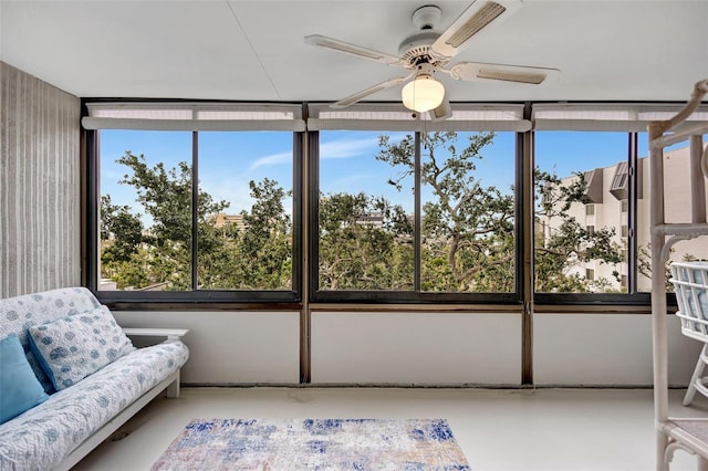 sunroom featuring ceiling fan and a wealth of natural light