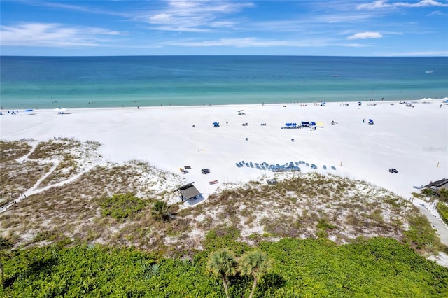 birds eye view of property with a view of the beach and a water view