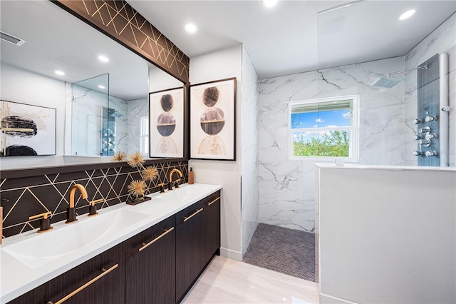 bathroom featuring vanity, decorative backsplash, and a tile shower