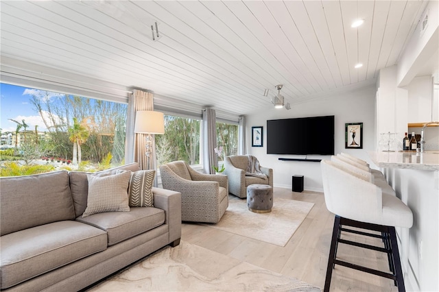 living room with lofted ceiling, sink, wood ceiling, and light wood-type flooring