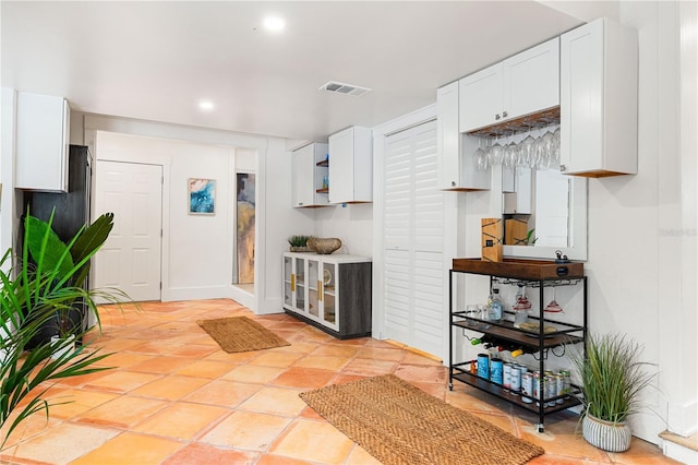 kitchen with white cabinetry and light tile patterned floors