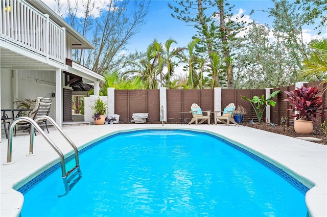 view of swimming pool featuring a patio area