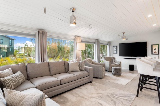 living room featuring lofted ceiling and light hardwood / wood-style floors