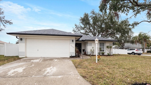 view of front of property with a garage and a front yard