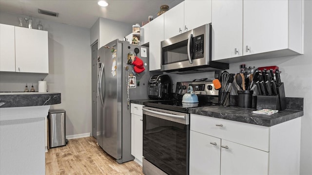 kitchen with white cabinetry, light hardwood / wood-style flooring, and appliances with stainless steel finishes