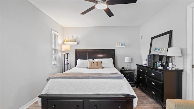 bedroom with wood-type flooring and ceiling fan