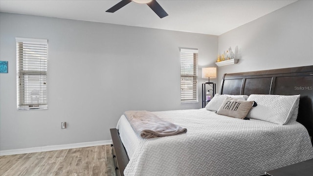 bedroom with light hardwood / wood-style floors and ceiling fan