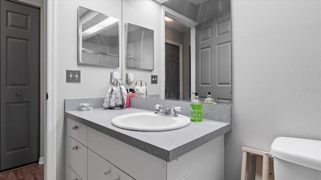 bathroom with vanity and hardwood / wood-style flooring