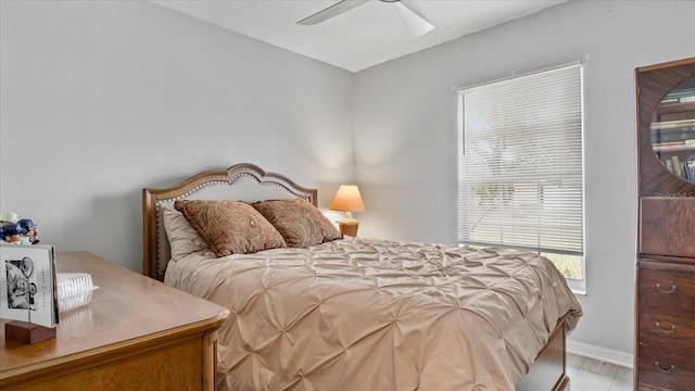 bedroom with ceiling fan and light hardwood / wood-style flooring