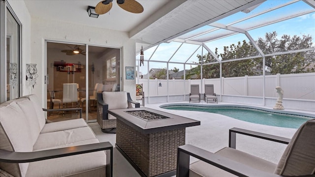 view of pool with a lanai, a fire pit, and a patio