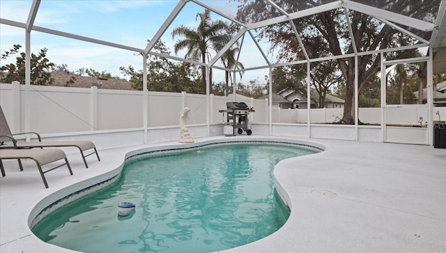 view of pool with a patio area and a lanai