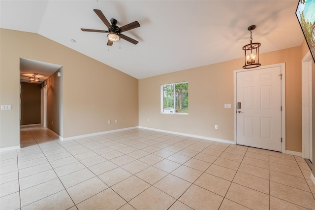 interior space with vaulted ceiling, ceiling fan, and light tile patterned floors