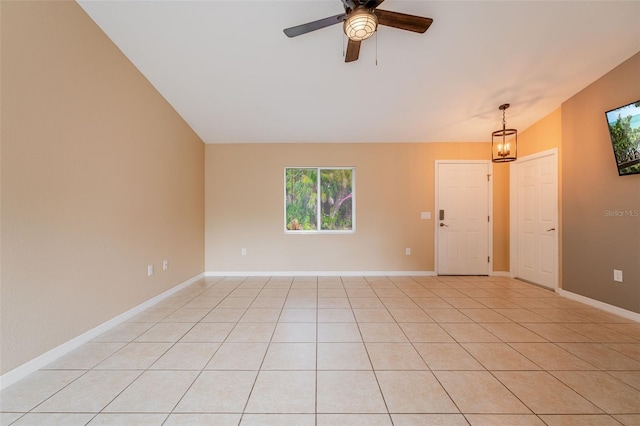 tiled spare room with ceiling fan