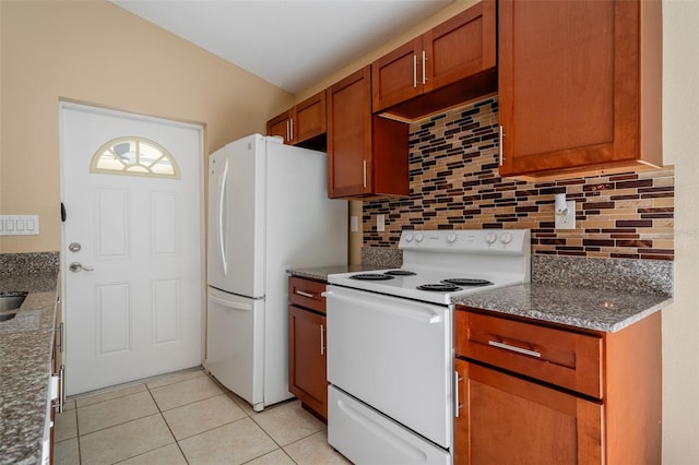 kitchen featuring white appliances, stone counters, decorative backsplash, and light tile patterned flooring