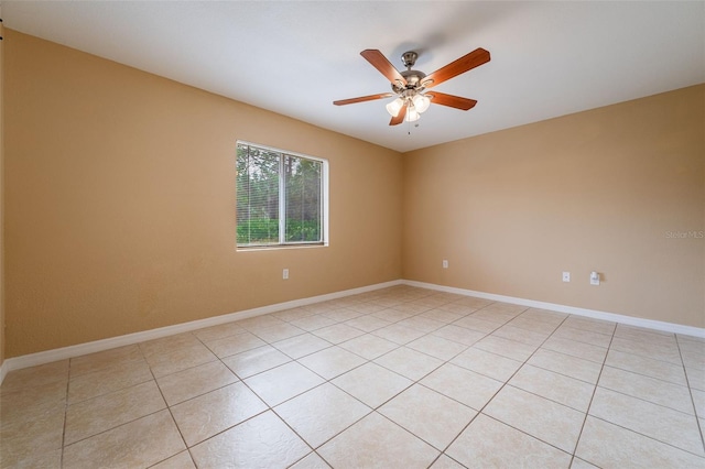 tiled spare room featuring ceiling fan