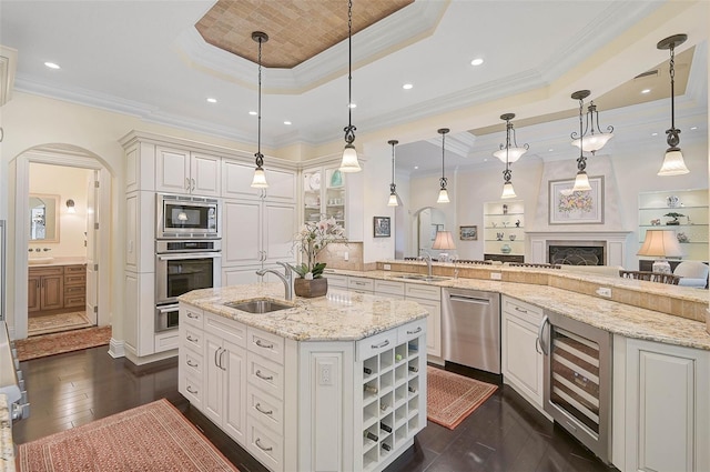 kitchen featuring hanging light fixtures, a raised ceiling, and appliances with stainless steel finishes