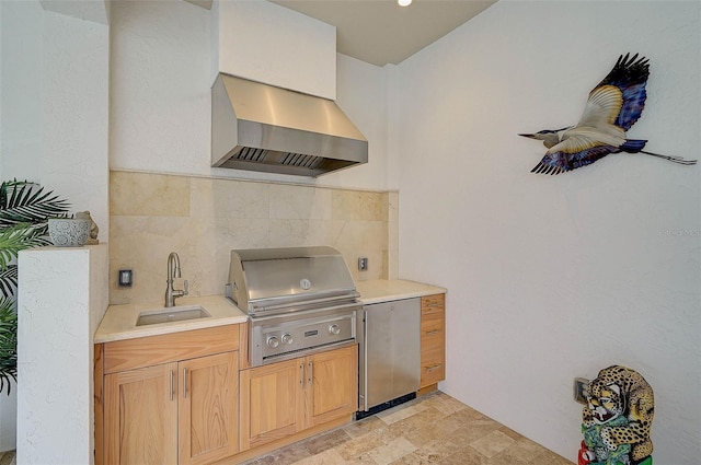 kitchen featuring fridge, sink, decorative backsplash, and wall chimney exhaust hood