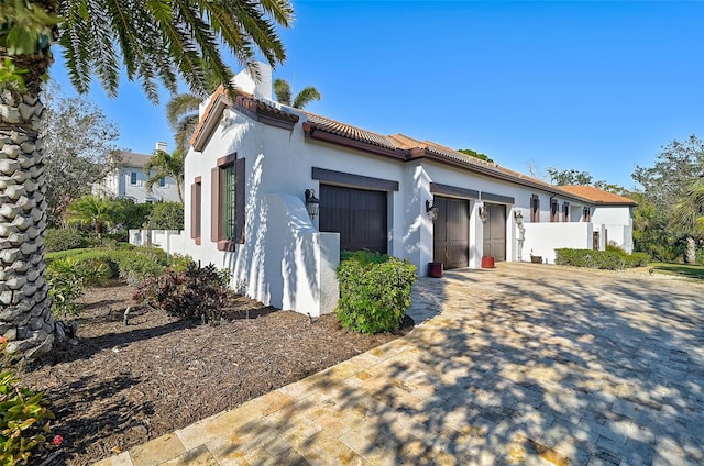 mediterranean / spanish-style home featuring a garage