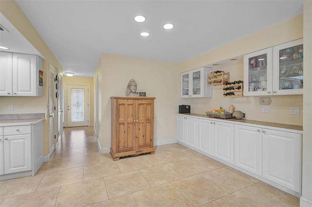 kitchen with light tile patterned flooring and white cabinets