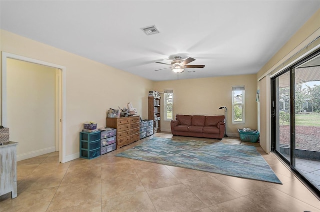 tiled living room featuring ceiling fan