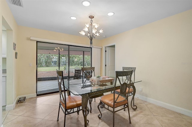 dining area featuring a notable chandelier and light tile patterned floors