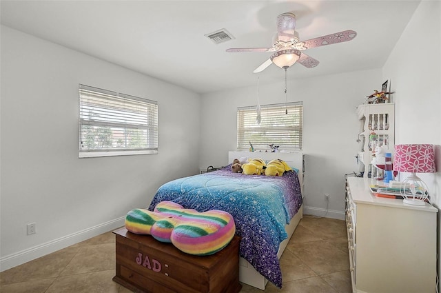 tiled bedroom featuring ceiling fan