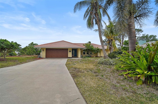 view of front of property with a garage and a front yard