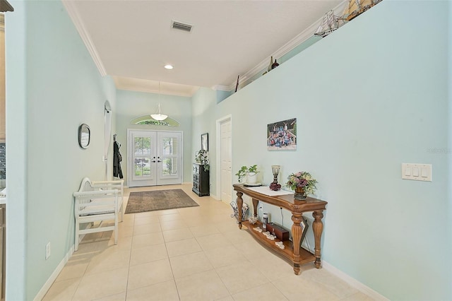 interior space with ornamental molding, light tile patterned floors, and french doors