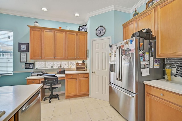 kitchen with built in desk, decorative backsplash, light tile patterned floors, stainless steel appliances, and crown molding