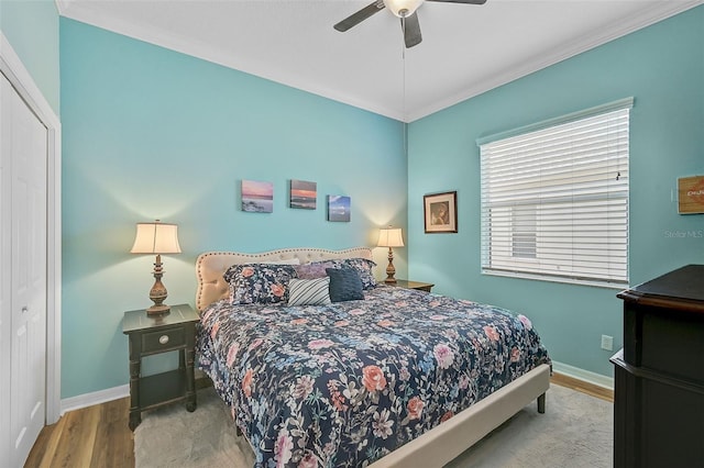 bedroom featuring ceiling fan, wood-type flooring, and a closet