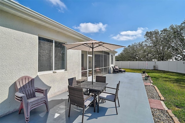 view of patio featuring a sunroom