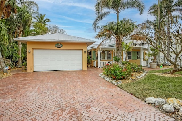 ranch-style house featuring a garage, a front lawn, and a porch