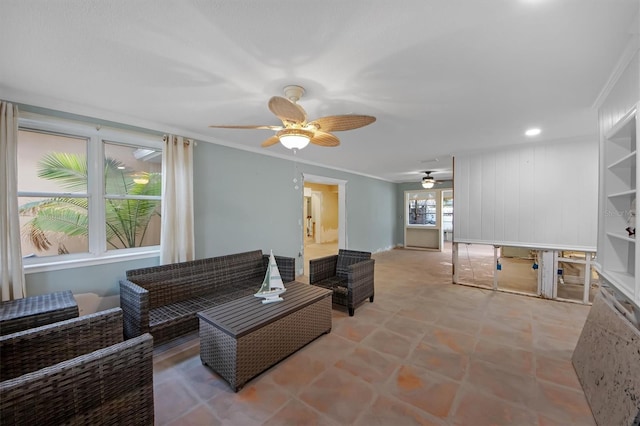 living room featuring crown molding and ceiling fan